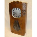 A 1930's French Art Deco-style wall clock with silvered octagonal dial in walnut angular case