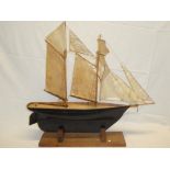 An old wooden scale built model of a two-masted schooner 30" long on wooden stand