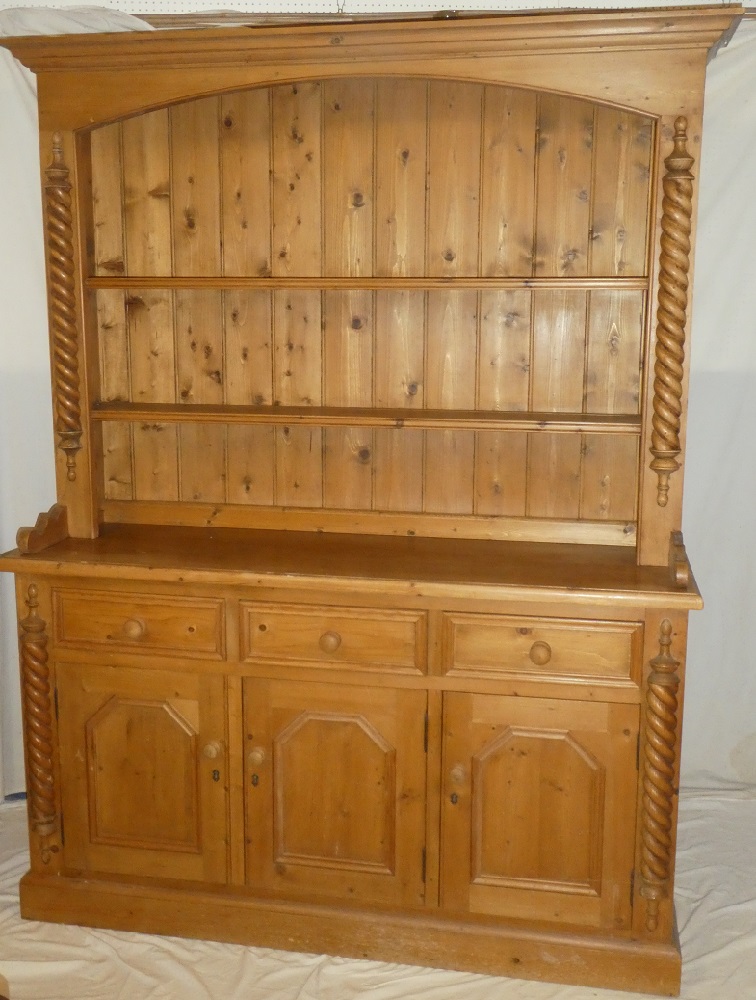 A good quality polished pine kitchen dresser with three drawers in the frieze and cupboard enclosed