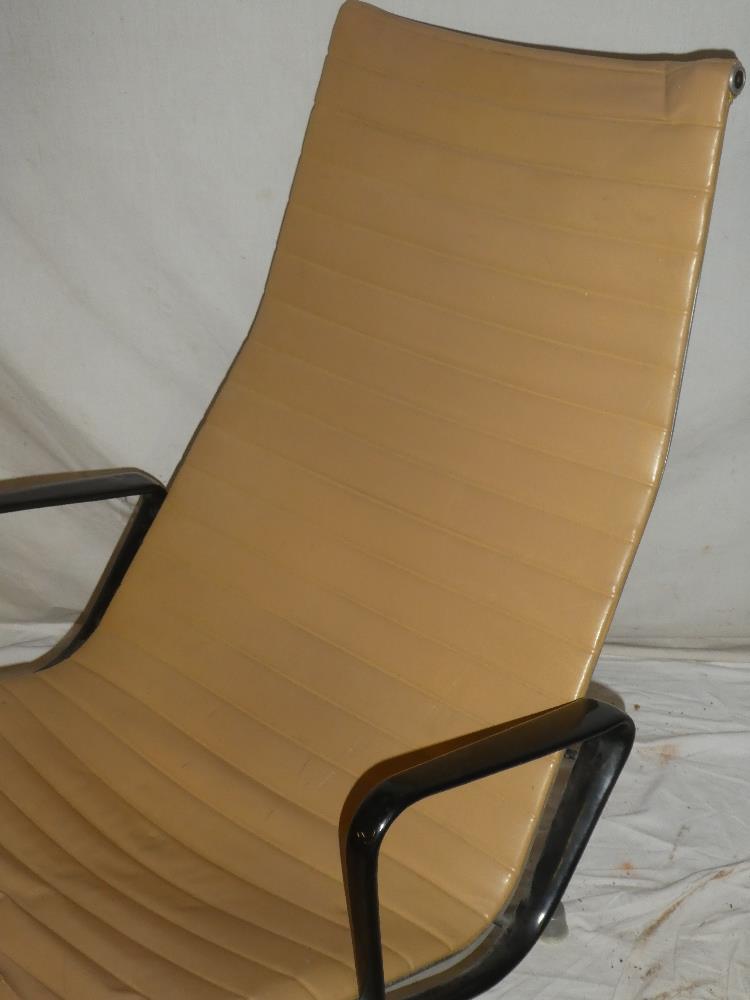 A 1960's aluminium and vinyl Eames swivel easy chair and matching footstool labelled "Eames Design - Image 2 of 4
