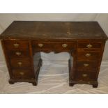 A 19th century figured walnut rectangular knee-hole desk with a single drawer in the frieze and