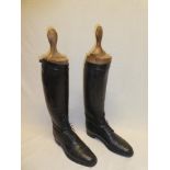 A pair of gentleman's black leather riding boots with fitted wooden trees