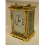 A French carriage clock with rectangular enamelled dial in brass traditional case