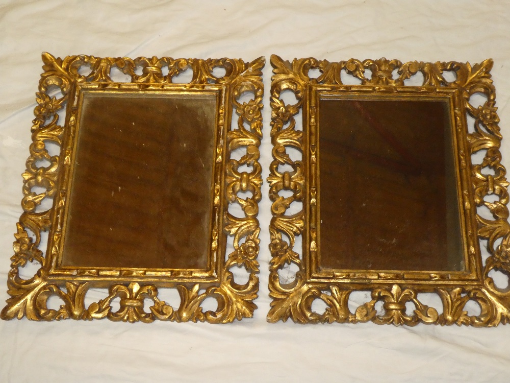 A pair of rectangular wall mirrors in gilt painted wood scroll frames 22" x 19"