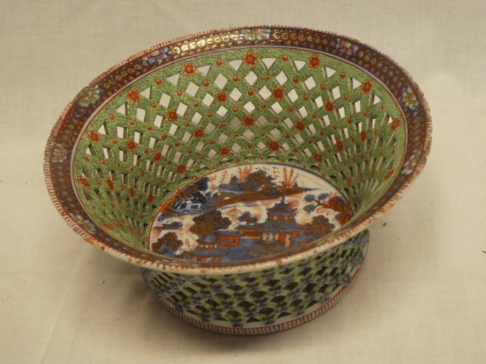 An unusual Chinese porcelain circular basket-shaped bowl with lattice-work sides and Eastern