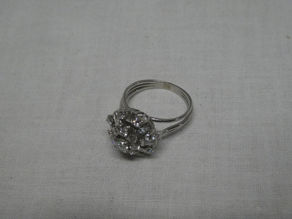 A modern white gold dress ring set numerous diamonds