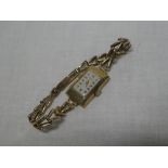 A lady's 9ct gold wrist watch with rectangular dial by Marvin with 9ct gold strap