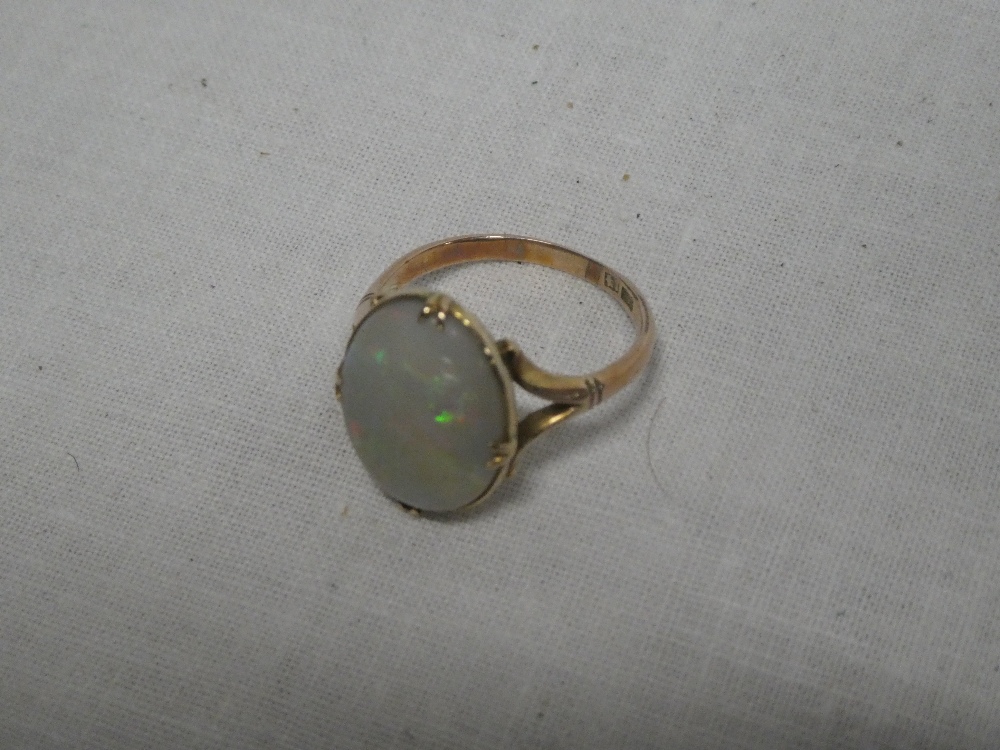 A Chinese gold dress ring set an oval opal
