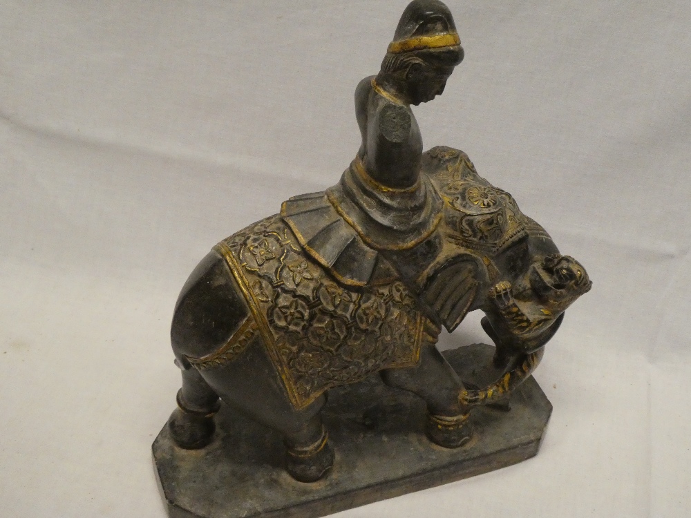 An unusual Eastern carved slate and gilt painted figure of a male riding an elephant, - Image 2 of 2
