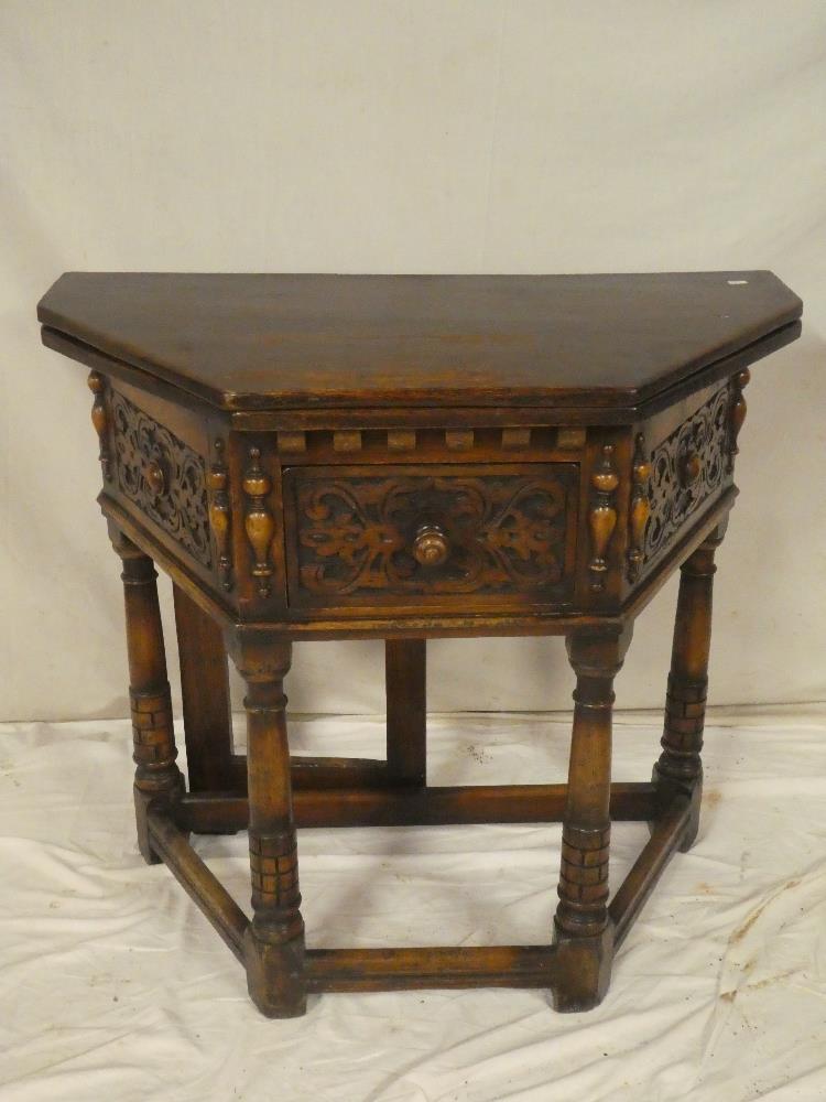 An old reproduction of a 17th Century side table with turnover-top,
