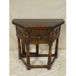 An old reproduction of a 17th Century side table with turnover-top,