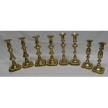 Four pairs of 19th century brass baluster-shaped ejector candlesticks