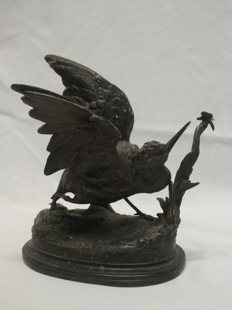 A bronzed spelter figure of a snipe on oval rustic base after P Comolera,