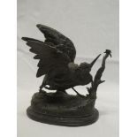 A bronzed spelter figure of a snipe on oval rustic base after P Comolera,