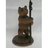 A Black Forest carved wood standing bear with staff,