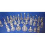 A collection of approximately thirty various cut glass and other scent bottles,
