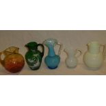 Five various Victorian and later decorative glass jugs including green tinted Mary Gregory-style