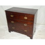 A small 19th Century mahogany chest of two short and two long drawers with brass ring handles on