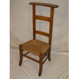 A Continental walnut ladder-back occasional prayer-style chair with rush-work seat on square legs