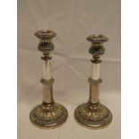 A pair of 19th Century Sheffield plate adjustable candlesticks on circular spreading bases