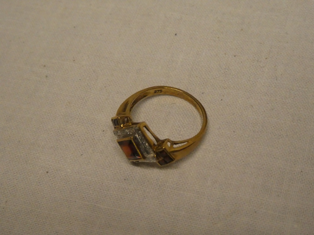 A 9ct gold dress ring set garnets