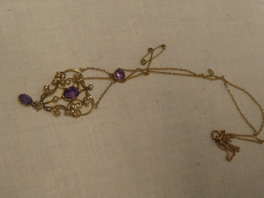 A 9ct gold mounted Art Nouveau pendant necklace set amethyst and seed pearls