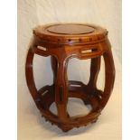 A Chinese rosewood barrel-shaped circular stool with raised decoration