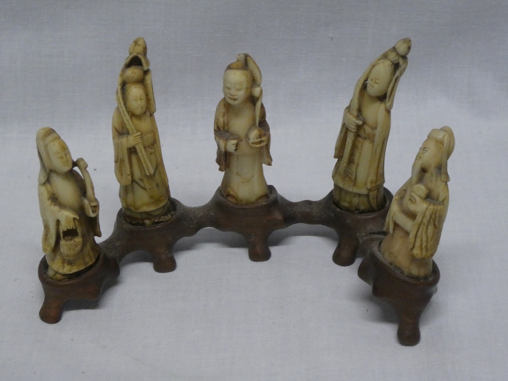 Five 19th Century Eastern carved ivory character figures,