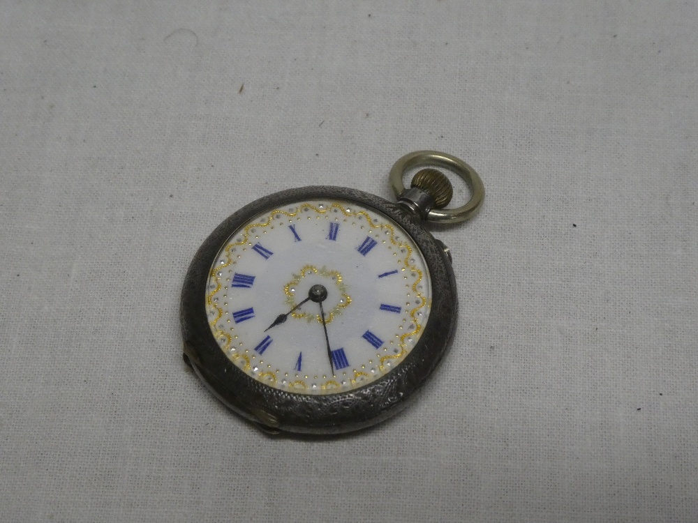 A ladies Continental silver fob watch with circular enameled dial in engraved case