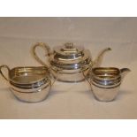 A good quality silver-plated three piece tea set comprising oval tea pot with scroll handle,