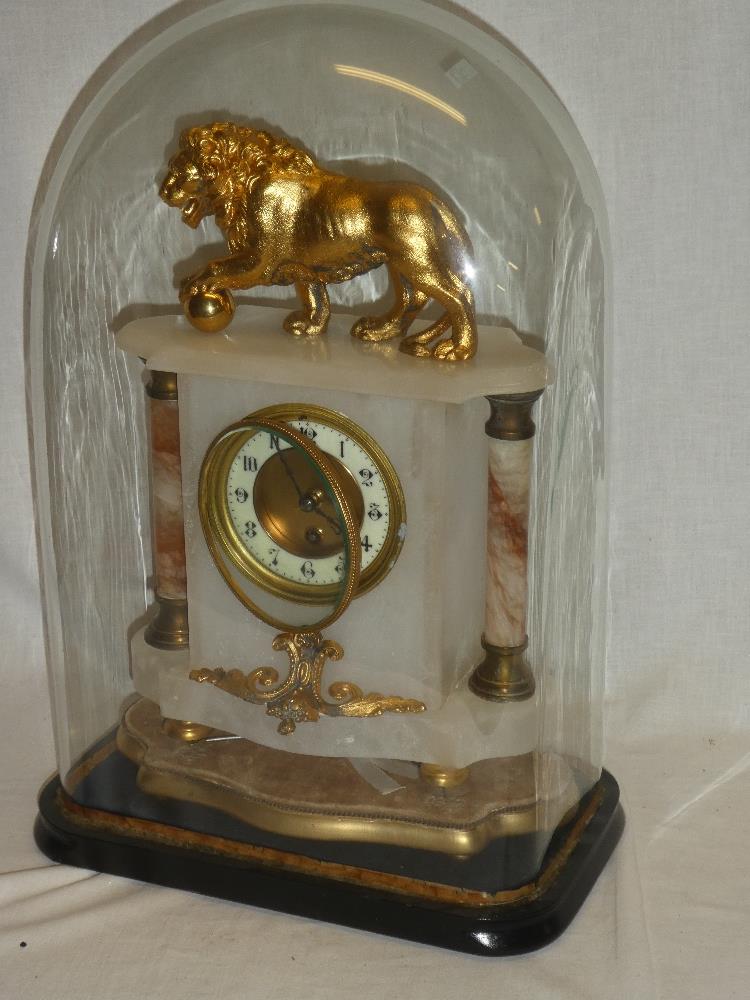 A good quality brass mounted alabaster mantel clock with circular decorated dial in polished case