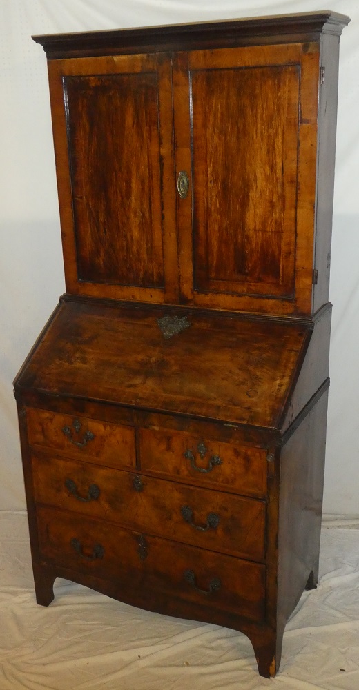 A George III mahogany cross banded bureau bookcase, the fitted interior with numerous drawers,