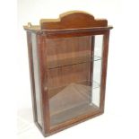 A small mahogany rectangular display cabinet with glass shelves enclosed by a single glazed door