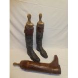 A pair of old leather riding boots with wooden trees by Jackson of Grosvenor Street,