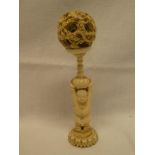 An 18th/19th Century Eastern carved ivory puzzle ball with figured decorated stem and dragon