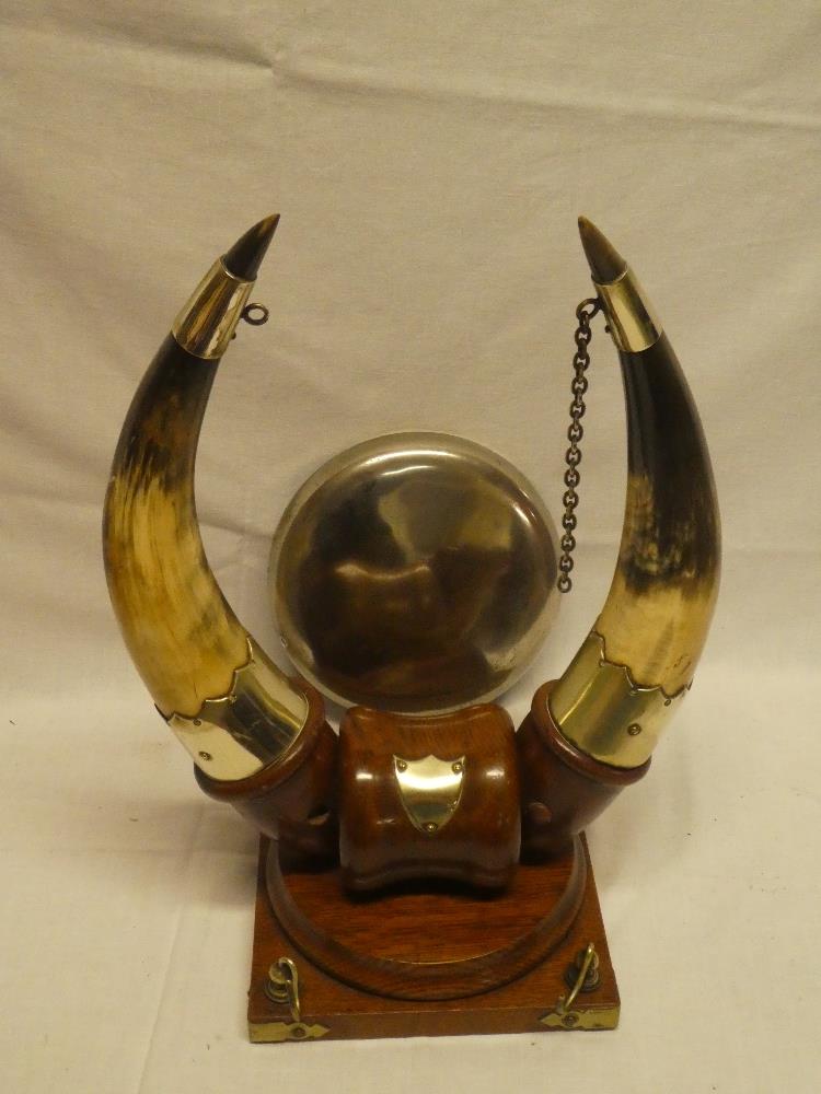 An unusual oak table gong stand with silver-plated natural horn supports