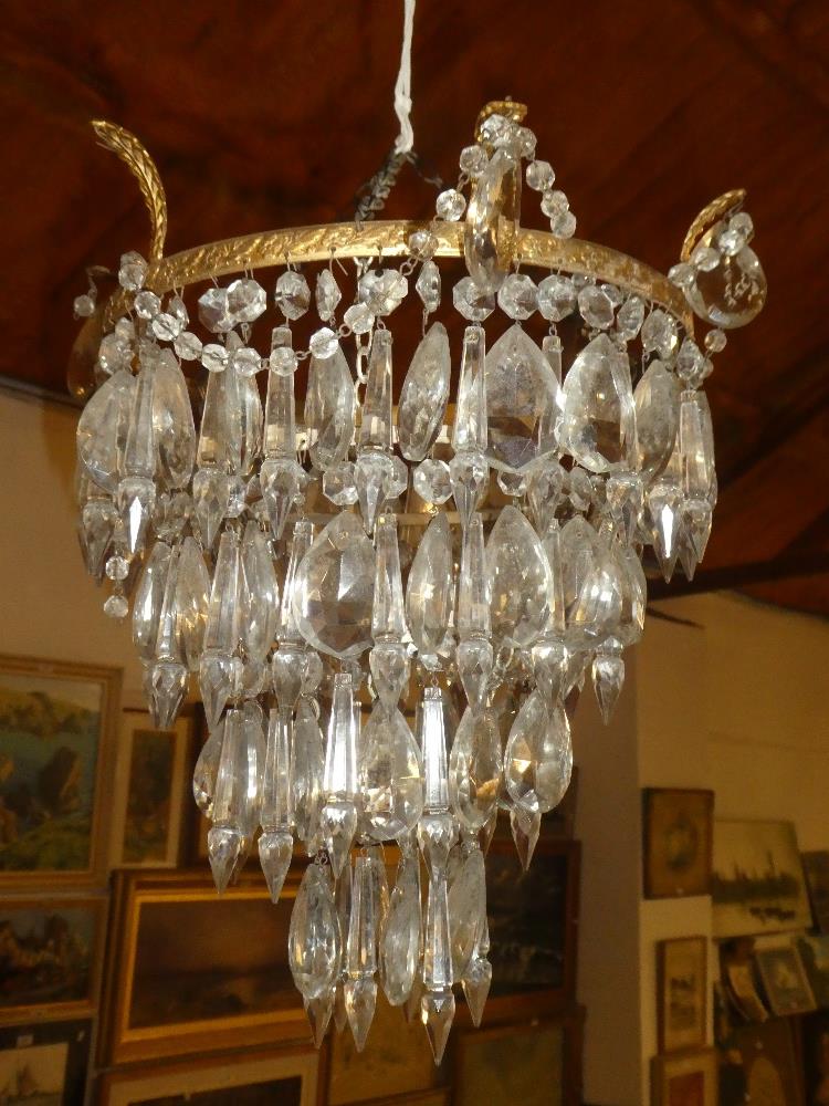 A brass four tier ceiling electrolier with glass lozenge droplet decoration