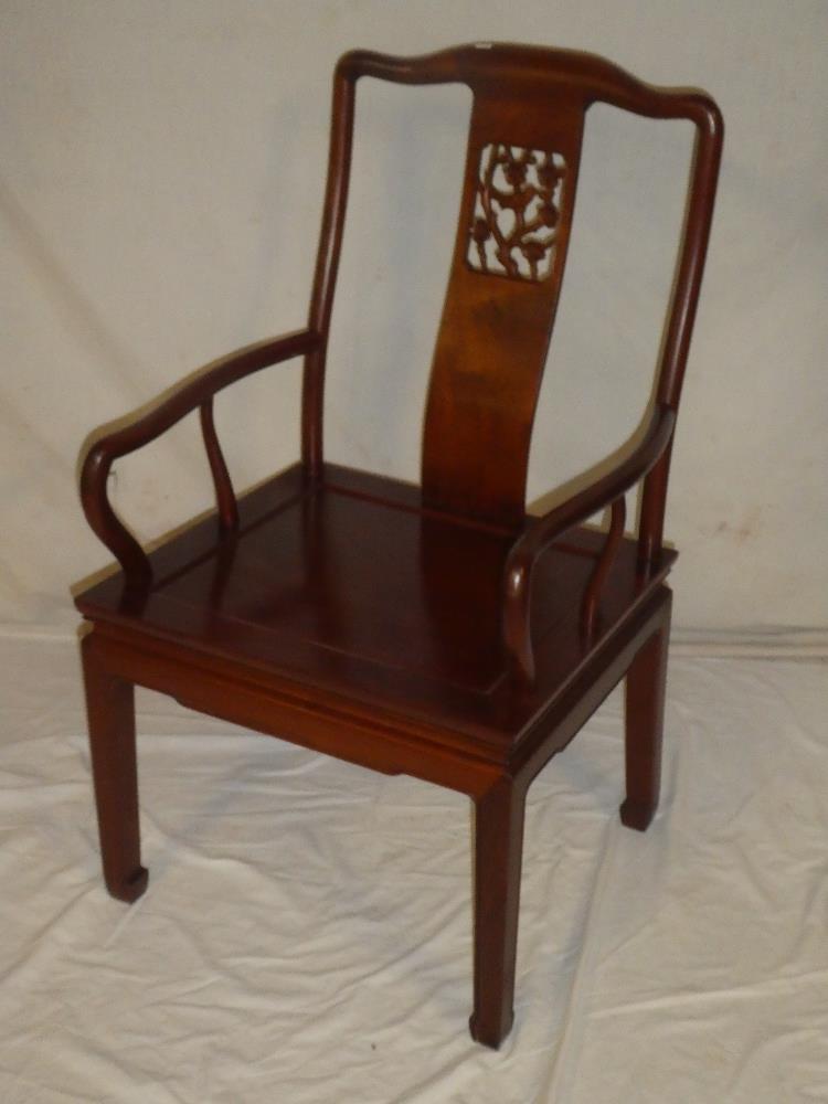 A good quality Chinese carved and polished mahogany carver armchair with bird decorated splat-back