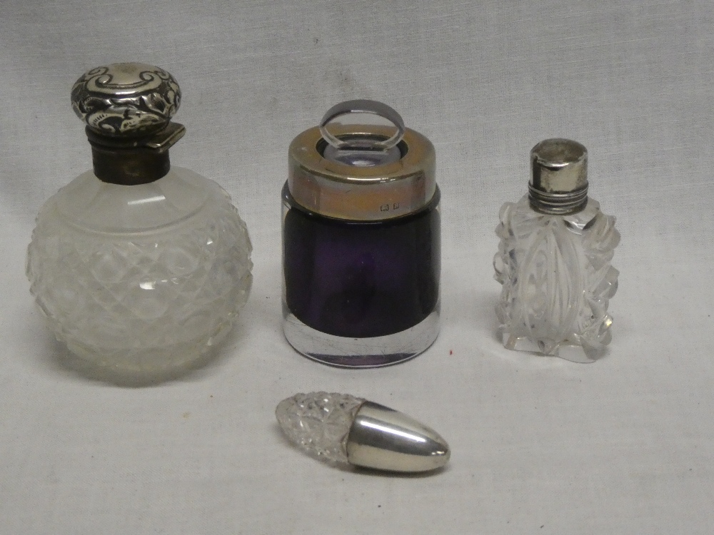 A cut-glass scent bottle with silver mounted top,