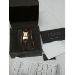 A ladies gold plated wristwatch by Gucci with leather wrap-around strap,