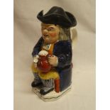 A 19th Century Staffordshire pottery traditional Toby jug depicting Toby wearing a tricorn hat and
