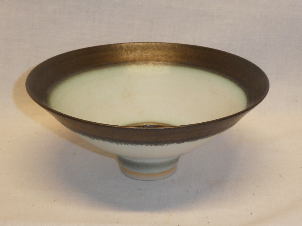 A Studio china circular tapered bowl by Peter Wills with cream and oxide decoration,