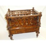 A Victorian inlaid figured walnut rectangular Canterbury with carved panels and a single drawer in