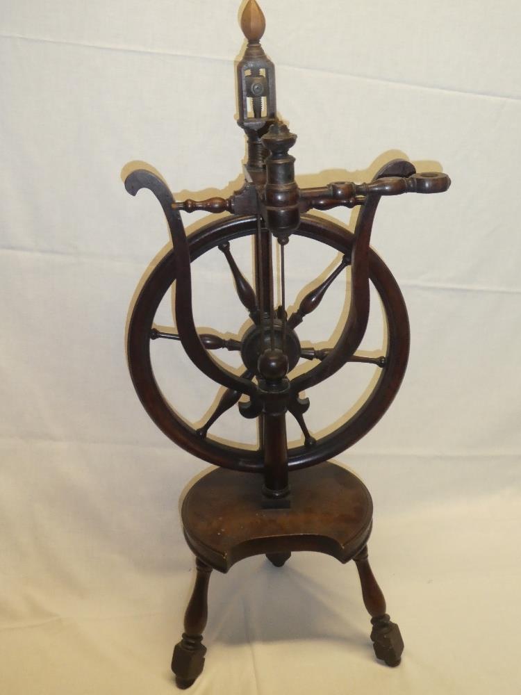 An unusual 19th century mahogany spinning wheel with turned supports 33" high
