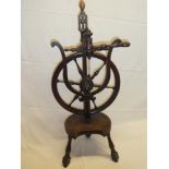 An unusual 19th century mahogany spinning wheel with turned supports 33" high