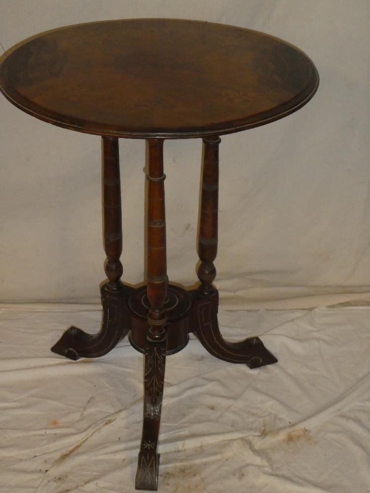 A Victorian inlaid walnut circular occasional table on three turned columns with scroll feet