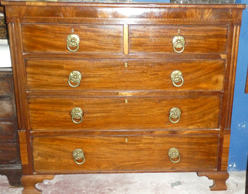 A mid Victorian inlaid mahogany chest of two short and three long drawers with brass ring handles