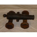 An old iron ornamental signal cannon with 19" tapered barrel and part four wheel carriage
