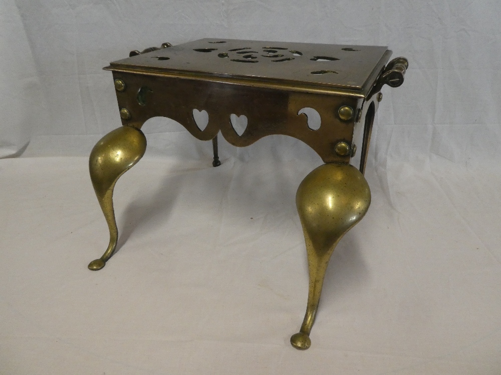 An early 19th Century brass rectangular two handled footman on cabriole-style legs,