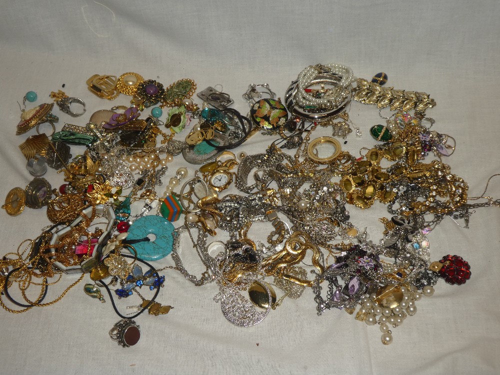 A large selection of various costume jewellery including brooches, earrings, dress rings,